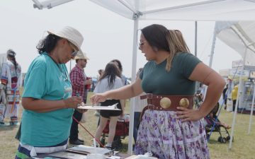 A native woman from North Dakota Native vote recruiting new electric cooperative members to join the energy task force at the Spriit Lake powWow