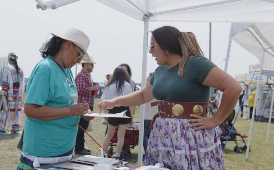 A native woman from North Dakota Native vote recruiting new electric cooperative members to join the energy task force at the Spriit Lake powWow